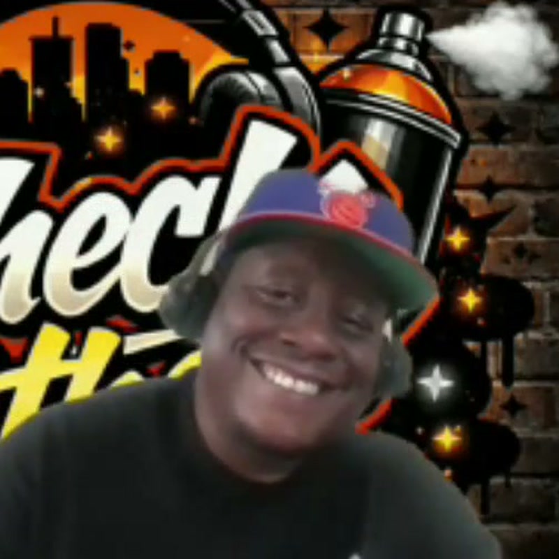 Echo EL Black in front of his graffiti backdrop